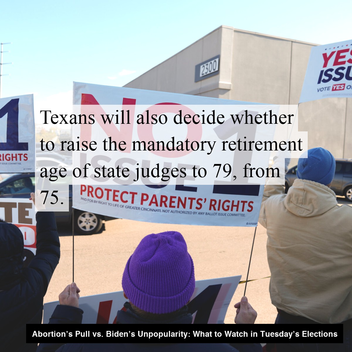 People hold signs outside an election office in Cincinnati urging people to vote No on a ballot referendum on abortion rights. Caption reads: Texans will also decide whether to raise the mandatory retirement age of state judges to 79, from 75.